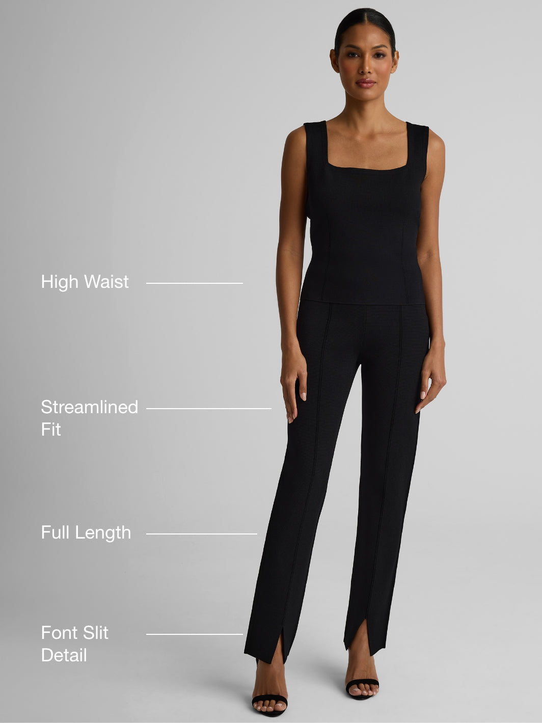 Woman wearing black dani pants over gray background