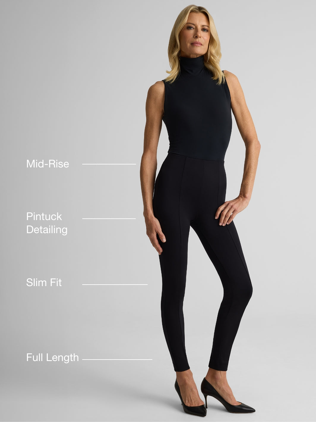 Woman wearing the Jillian pants in black over gray background